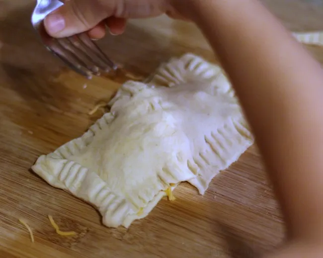 child making air fryer breakfast pockets