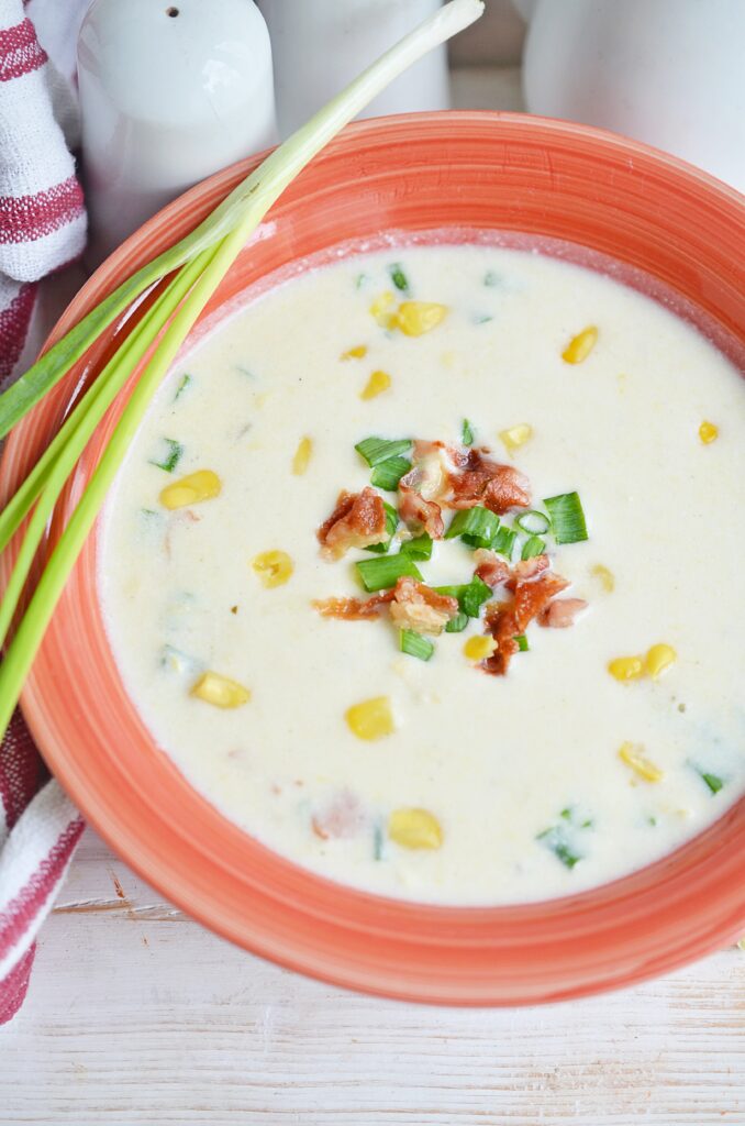 tall picture of corn chowder in a bowl