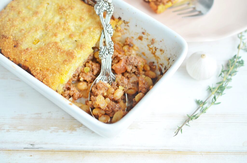 cornbread casserole in a white dish 