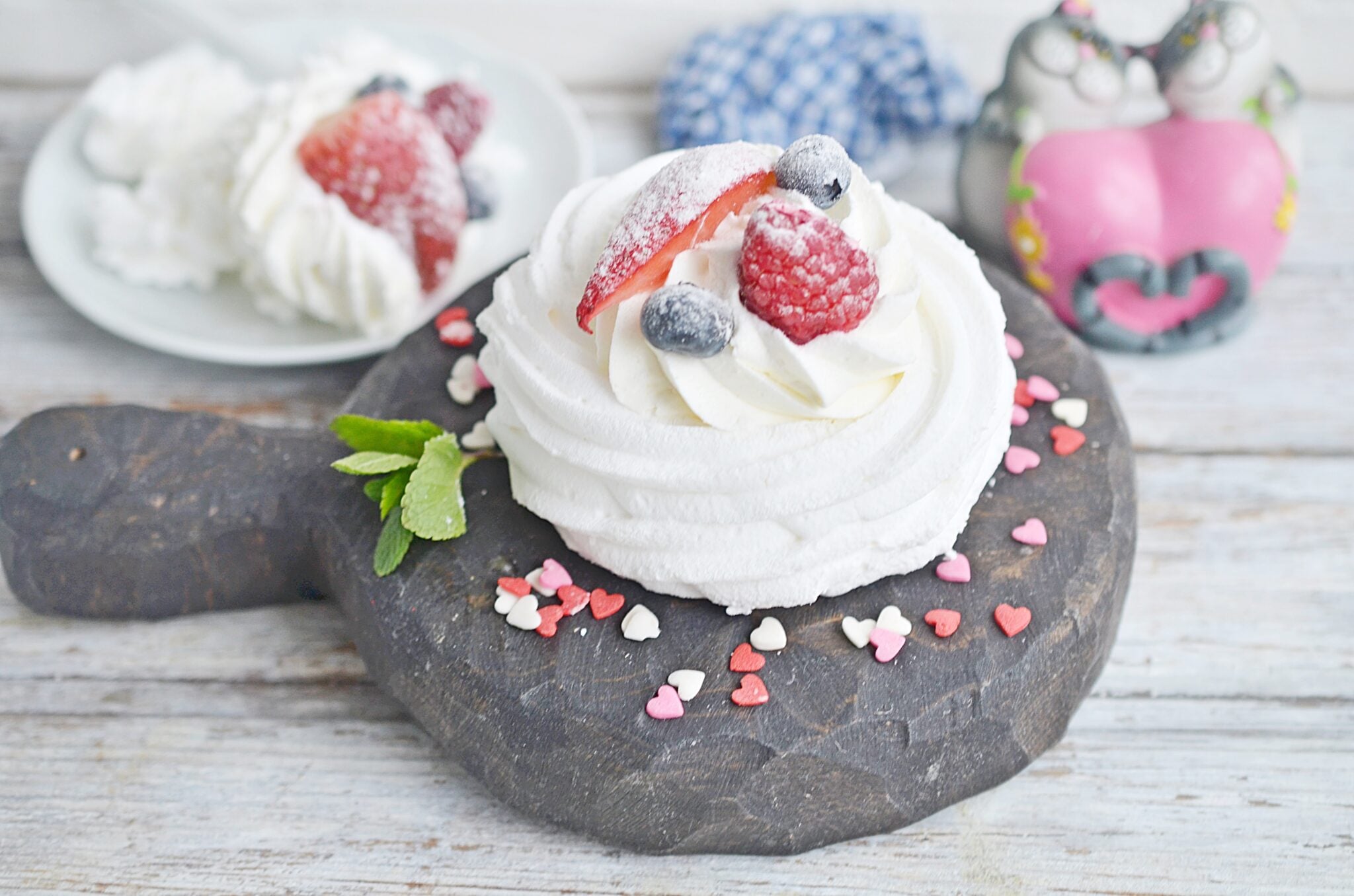 Side view of meringue cookie with berries.