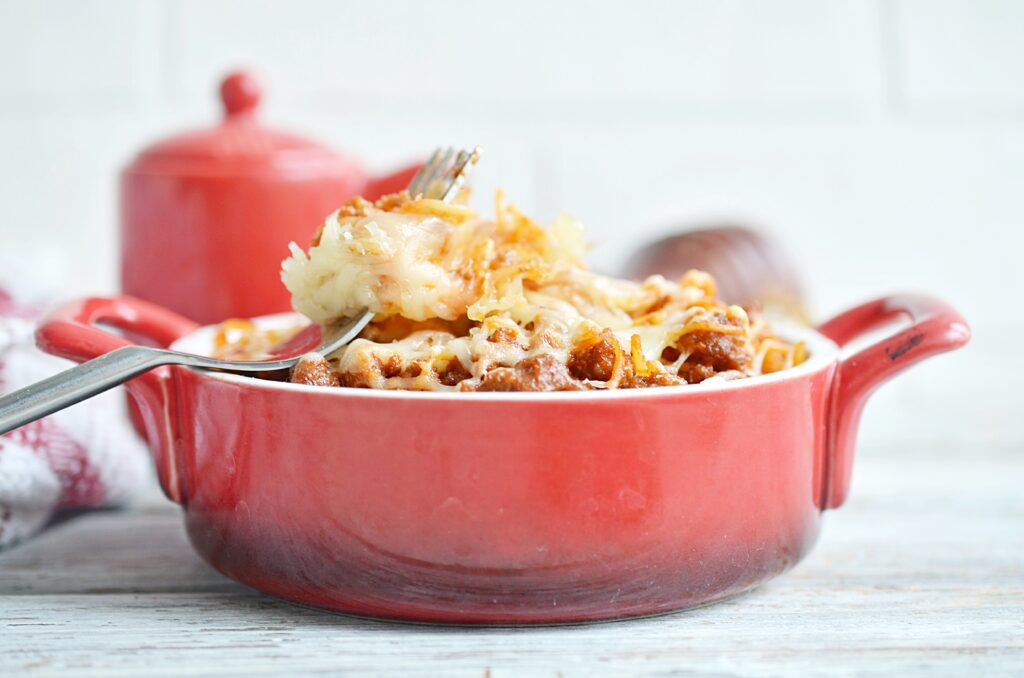 Spaghetti Casserole in a red dish with fork