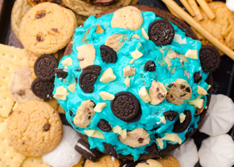 bowl of cookie monster dip with cookies and pretzels